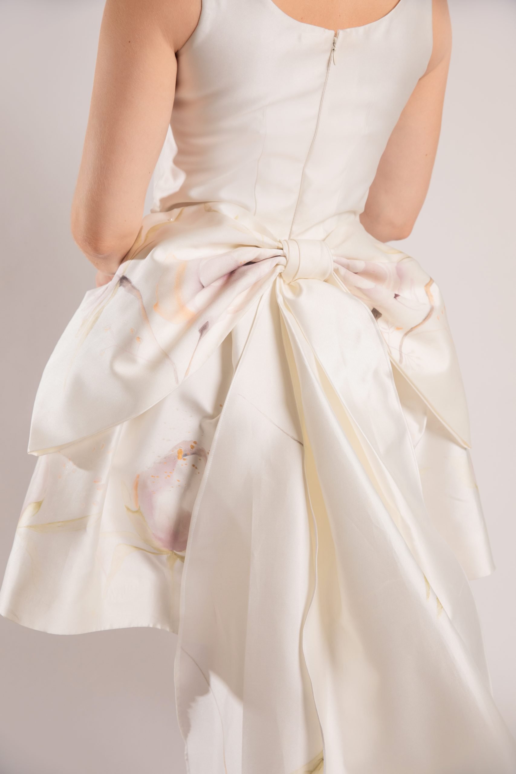 details of hand painted detachable bow with dangling leaves and branches