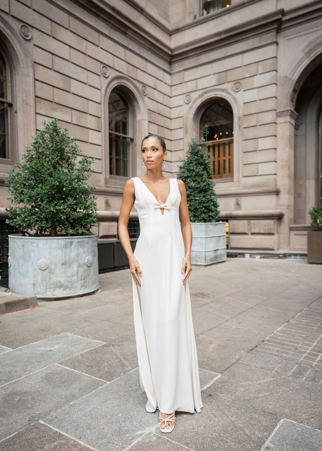 A-line crepe back satin wedding gown featuring bow detail and scoop back