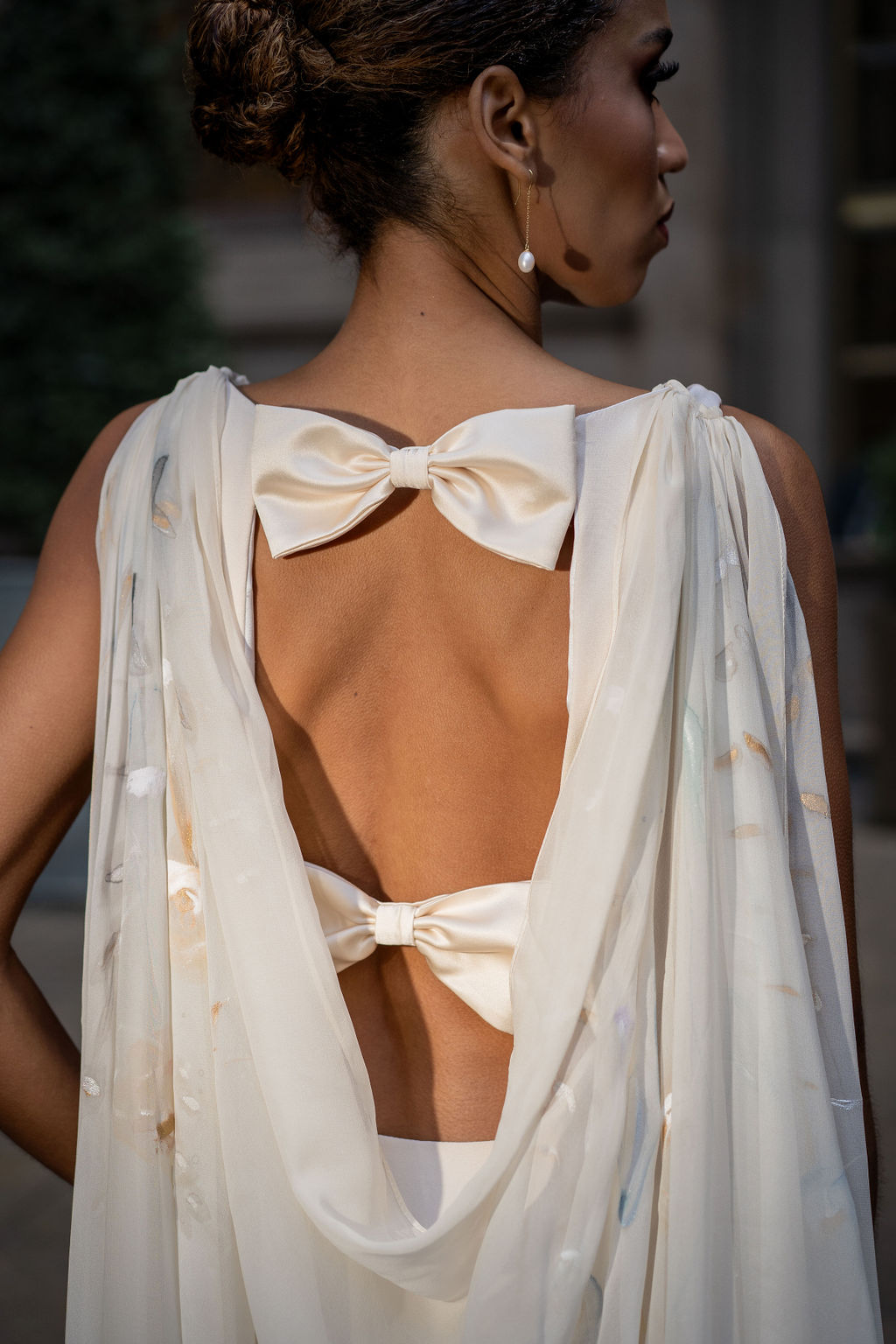 Elegant couture bridal gown with crepe back satin and hand painted floral detailing