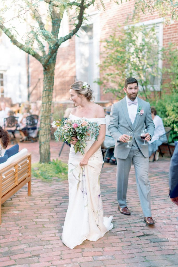 Bride walking in hand painted silk wedding dress with rose design