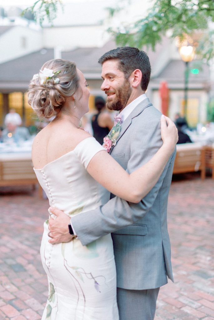 close up of custom floral painting on couture wedding dress