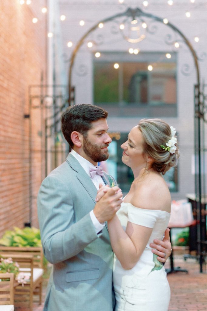 close up of happy couple dancing in luxury hand painted bridal gown