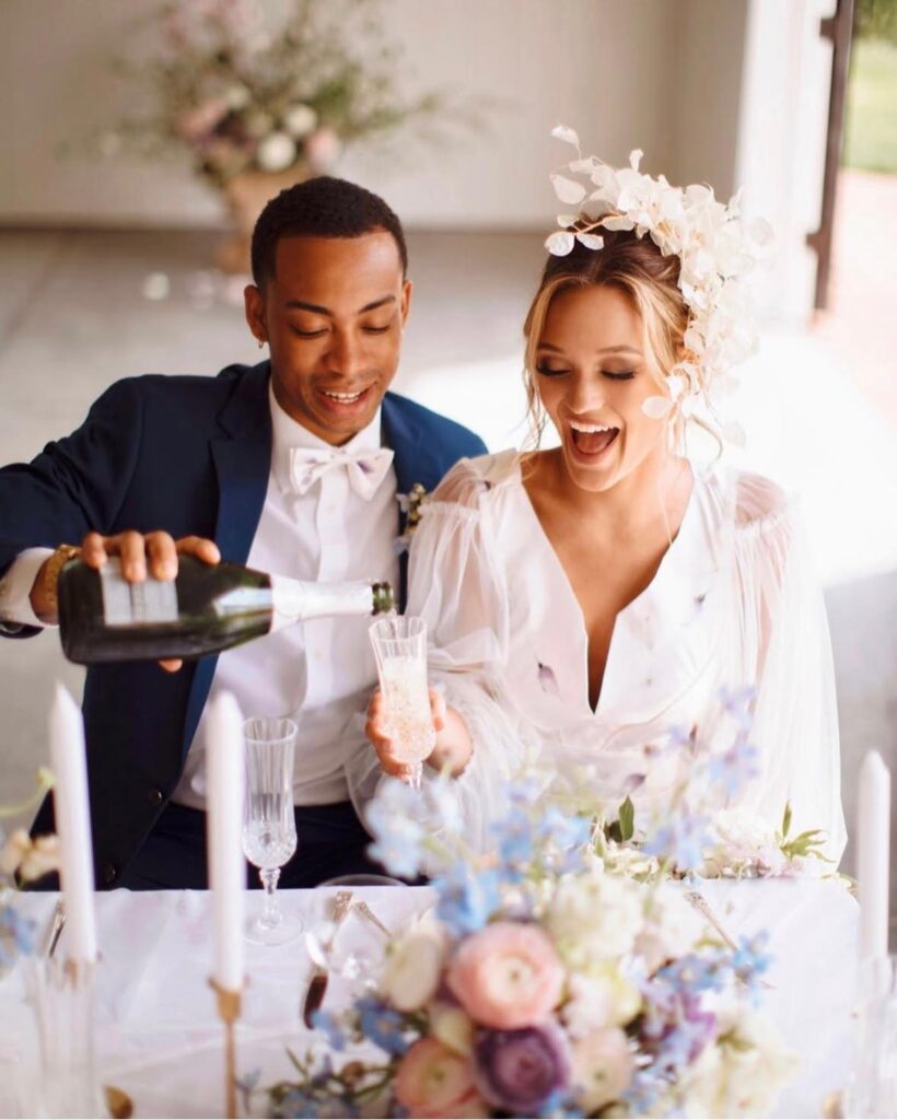 happy couple celebrating with flowers and champagne