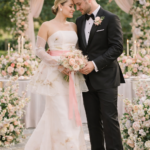 couple looking happy wearing ZB couture hand painted wedding dress in shades of blush and pinks